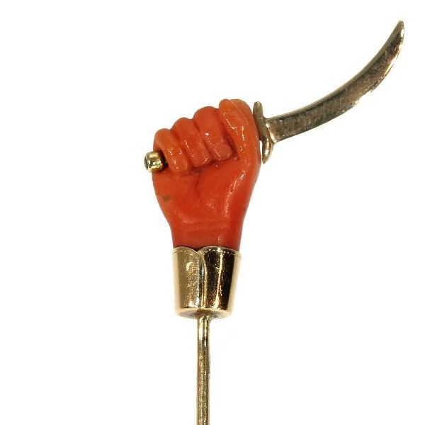 Victorian gold stickpin, cuffed coral hand holding large knife or small sword